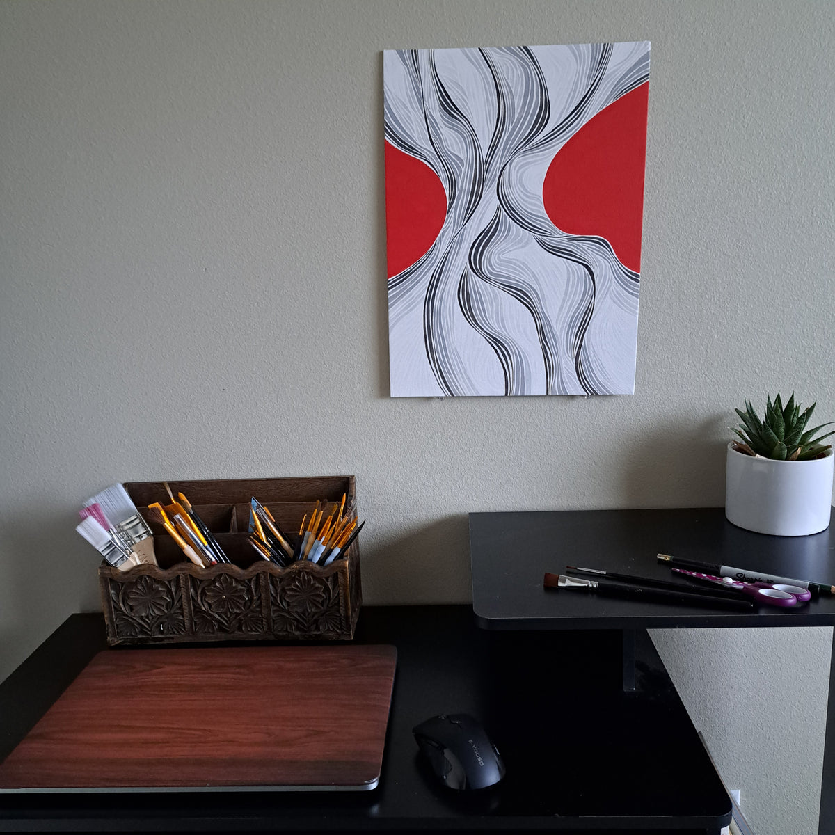 Staged photo of the "Grooves" painting hung up on a wall behind a desk