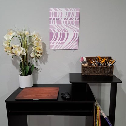 Staged photo of the "Expanding Wave" painting hung up on the wall behind a desk